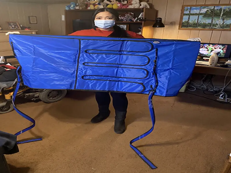 Healthcare specialist demonstrating a custom compression garment for lymphedema treatment.